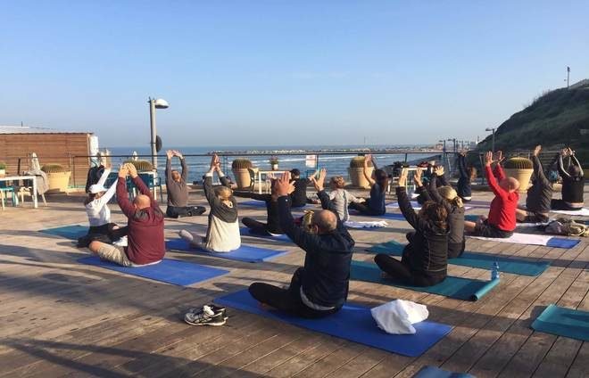 Group Yoga in Tel Aviv beach