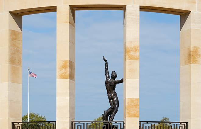 Visit the Normandy American Cemetery and Memorial. Overlooking the eastern end of Omaha Beach, the American cemetery in the village of Colleville-sur-Mer holds the bodies of 9387 soldiers who died during the Normandy campaign.